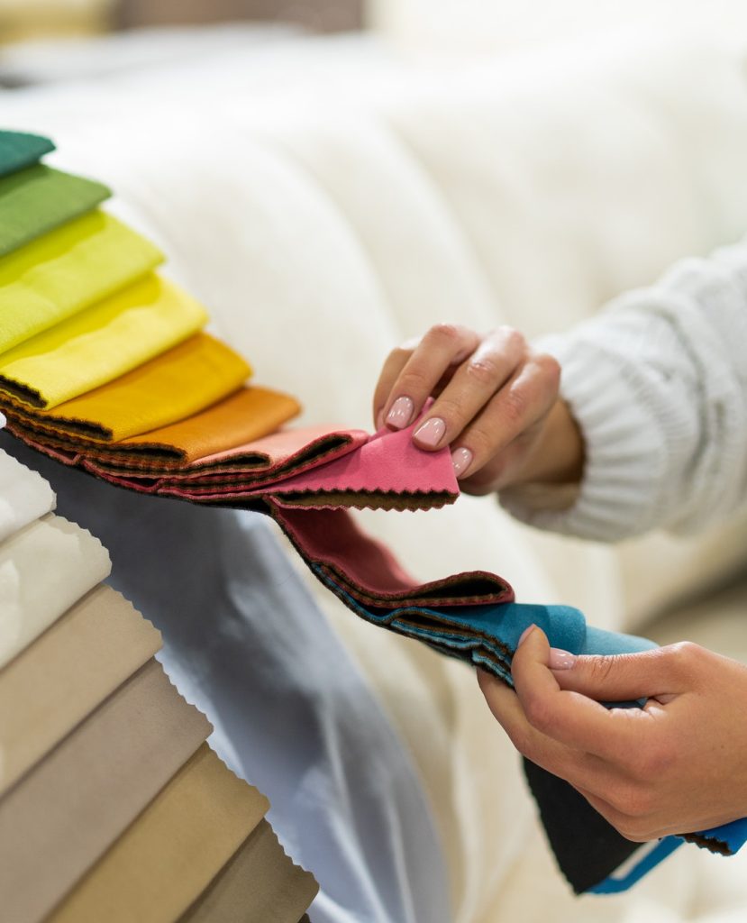 the-woman-chooses-the-fabric-on-the-sofa-textile-industry-background-tissue-catalog.jpg